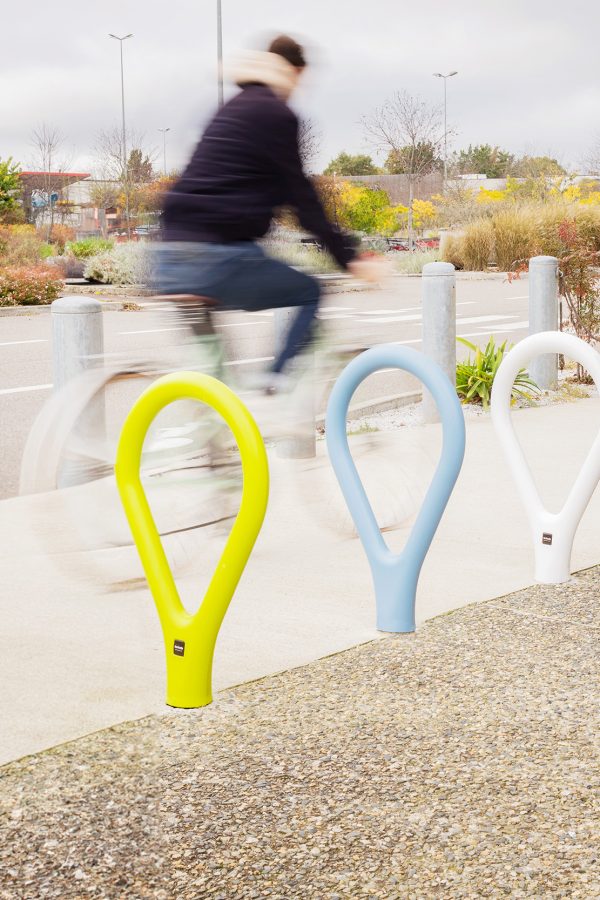 Street installation of outdoor bike racks in multiple colors